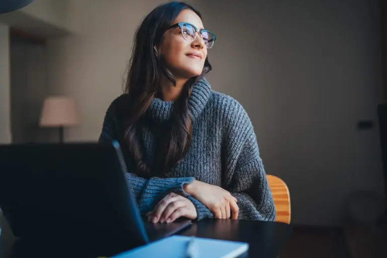 woman sitting near laptop