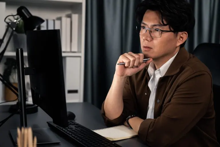 man thinking at computer