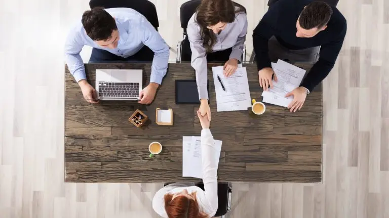 business meeting handshake overhead