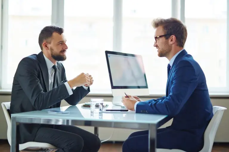 two businessmen meeting at desk