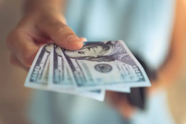 hand holding multiple dollar bills